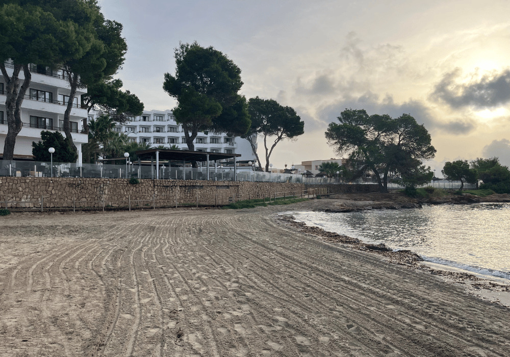 Sandy beach leading to a hotel